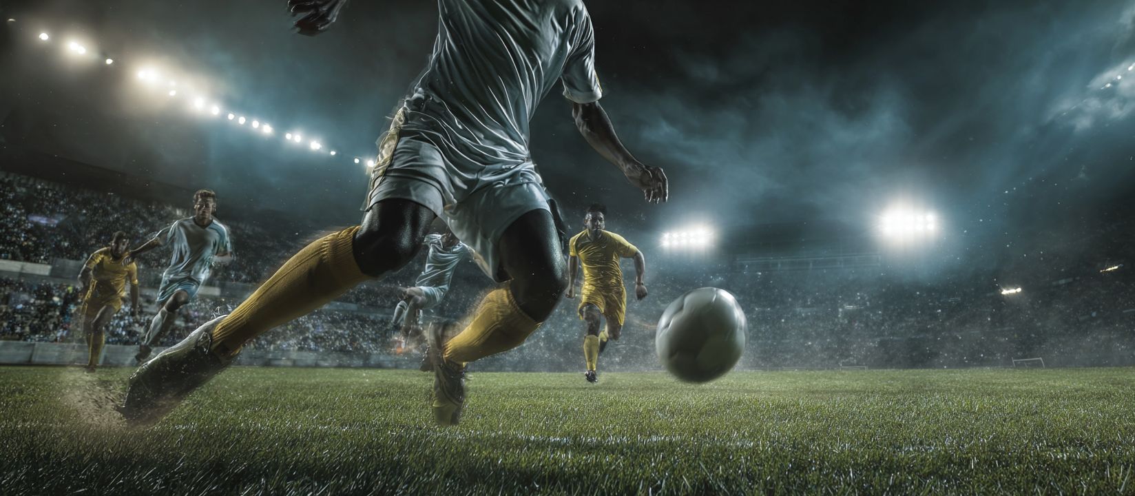 Intense soccer match under stadium lights, showing Ywkk’s thrilling sports betting atmosphere.